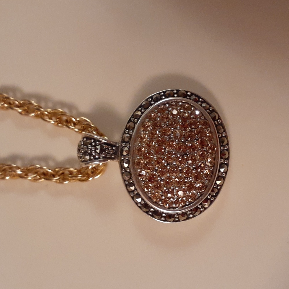 9.25  marcasite  pendant with gold druzy center